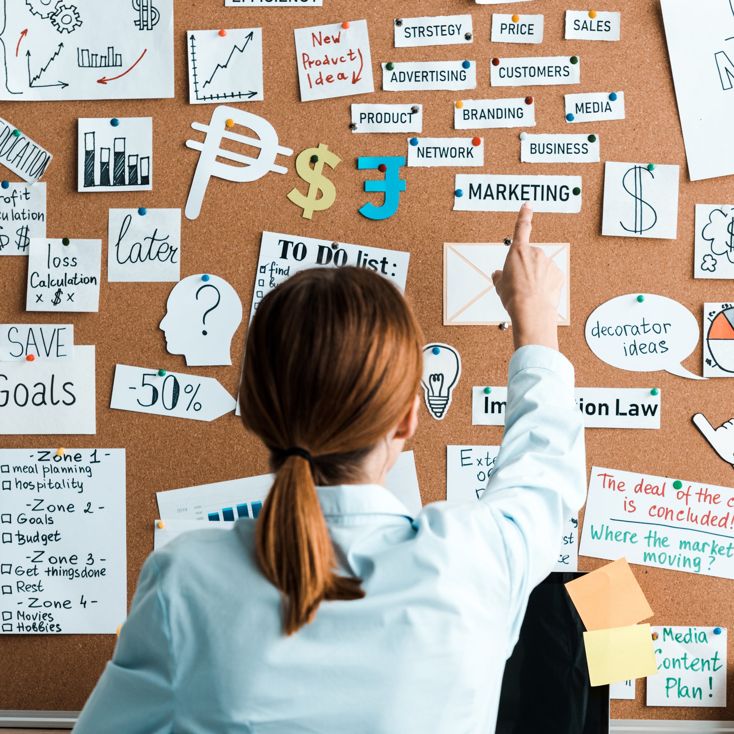 cropped view of businesswoman pointing with finger at marketing lettering on notice board cropped view of businesswoman pointing with finger at marketing lettering on notice board