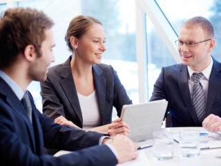 Group of confident business partners planning work at meeting