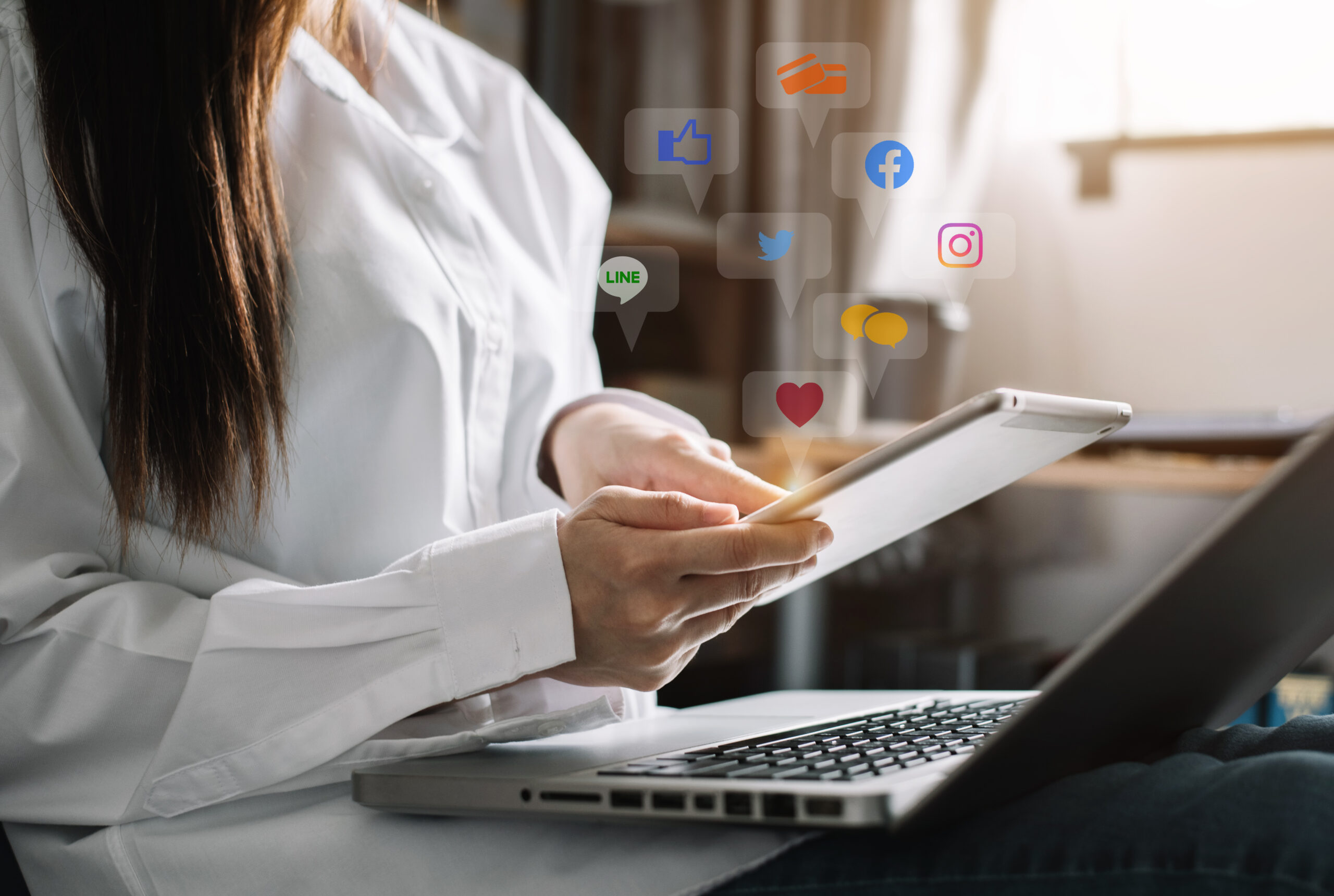 Social media and Marketing virtual icons screen of business women typing keyboard with laptop computer and tablet at home.